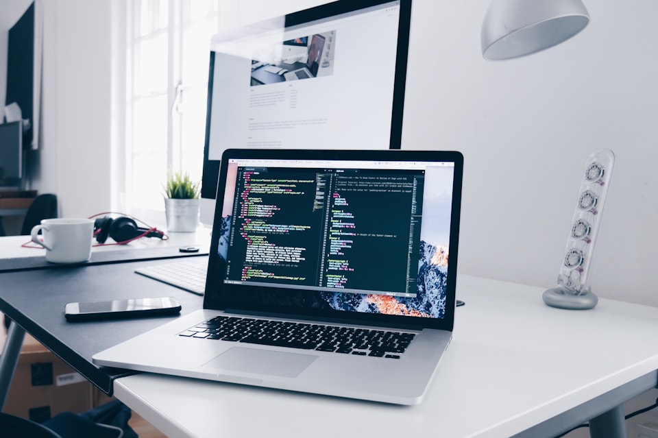Laptop on a desk showing design and development work